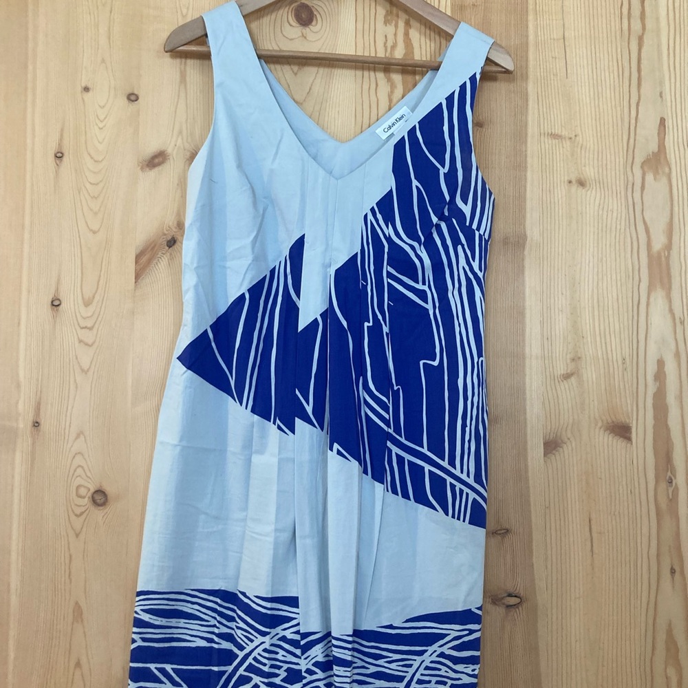 A light gray and blue cotton Calvin Klein dress with faux opening bottom front